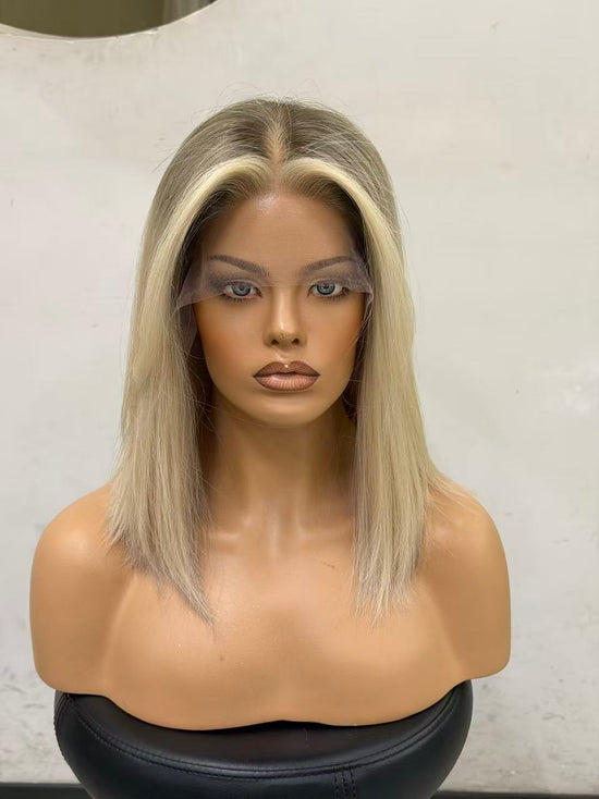 Mannequin head with a blonde wig on a plain background