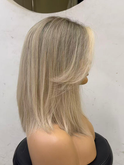 Mannequin head with blonde hair styled in a bob against a white background